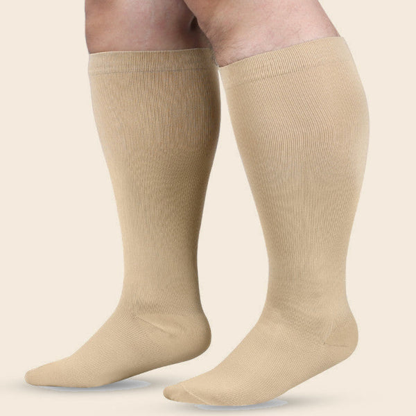 Wide calf compression socks in skin tone, worn on a pair of fuller calves